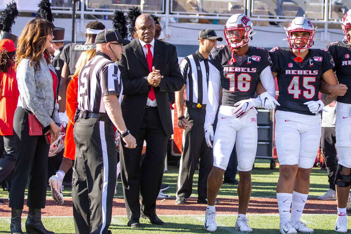 Former UNLV Rebels QB Randall Cunningham, center left, readies to take the field with players f ...