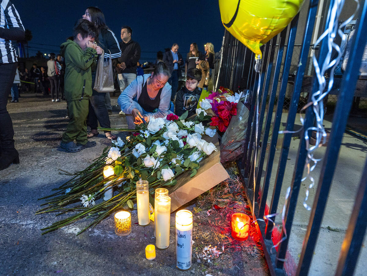 Candles are lit and flowers are laid at a makeshift memorial during a "Peace, Solidarity, ...