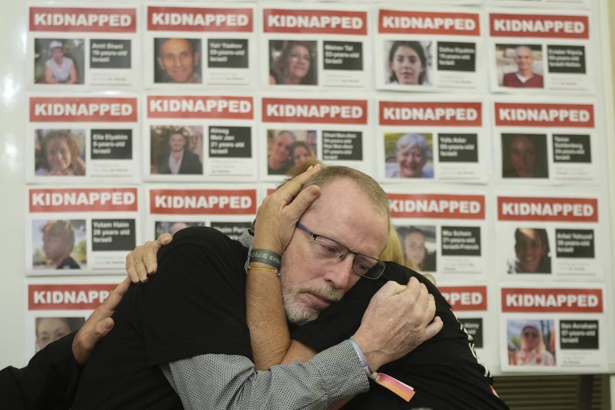 Orit Meir, right, mother of Israel hostage Almog Meir is comforted by Thomas Hand, left, father ...