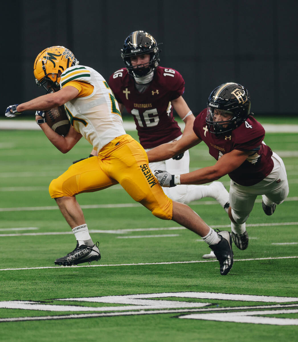 Faith Lutheran running back Sean Sampson (4) laps to take down Bishop Manogue running back Cody ...