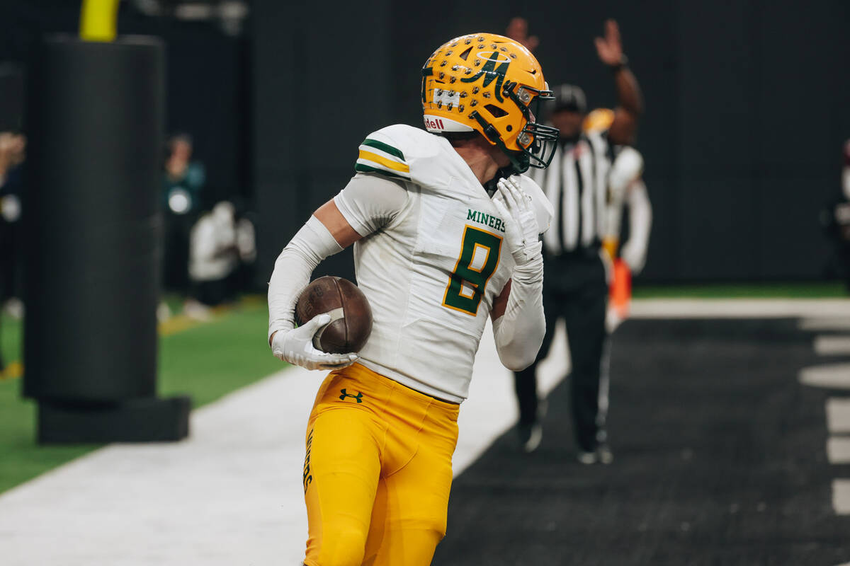 Bishop Manogue wide receiver Ben Scolari (8) looks back at his teammates after running into the ...