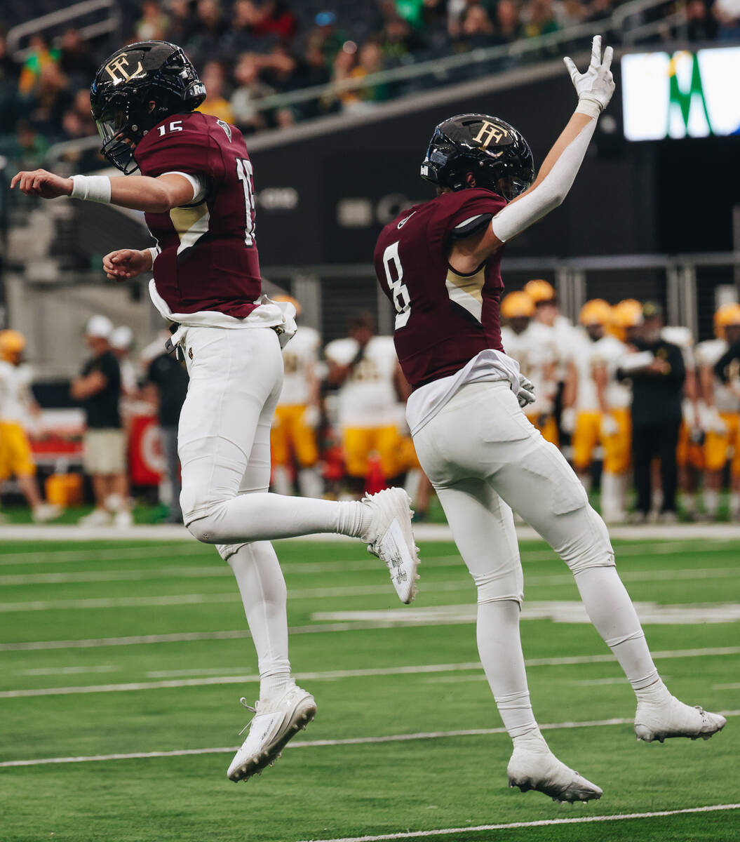 Faith Lutheran quarterback Alex Rogers (15) and tight end Cole Keith (8) celebrate a touchdown ...