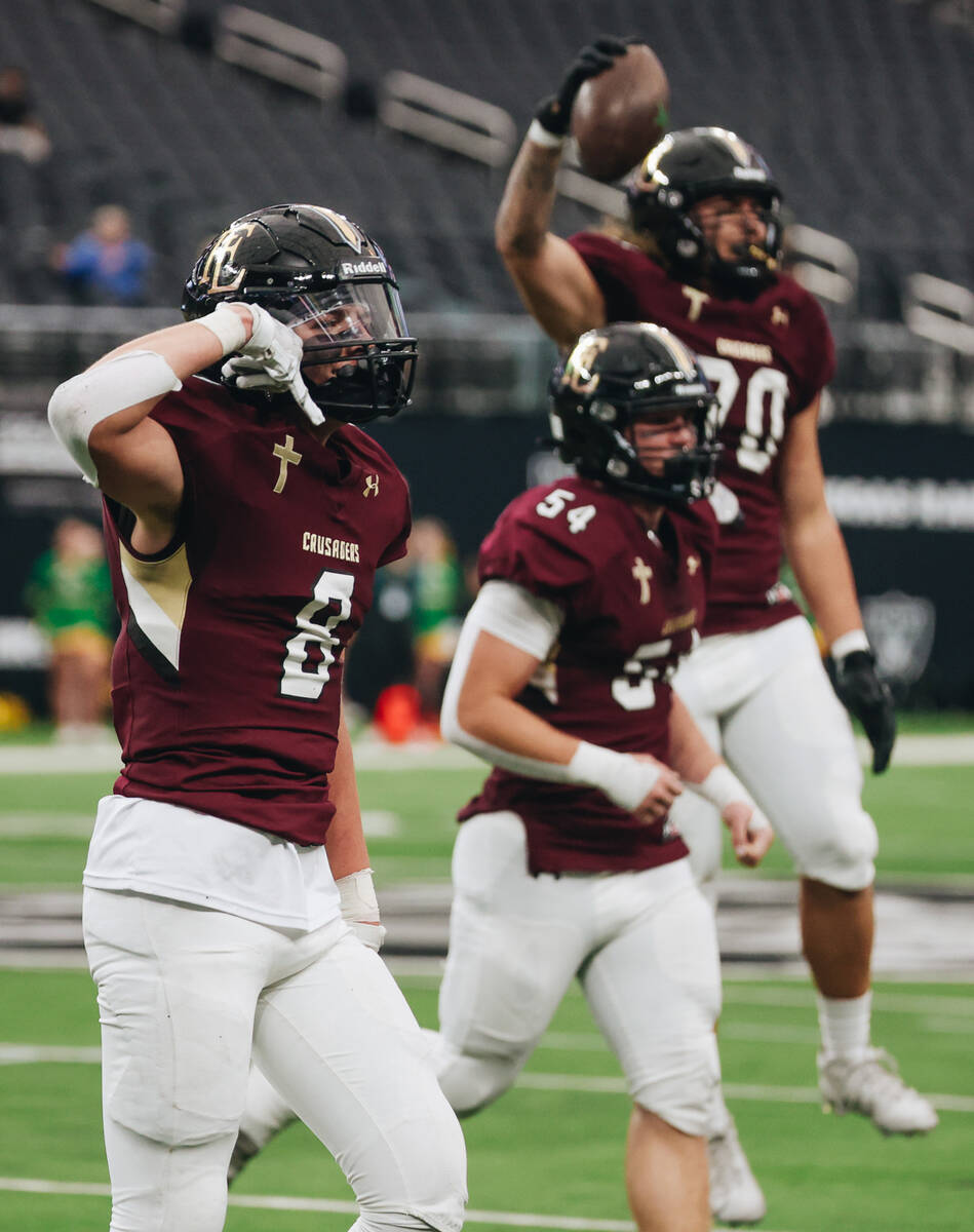 Faith lutheran players celebrate intercepting the ball from Bishop Manogue during a class 5A Di ...