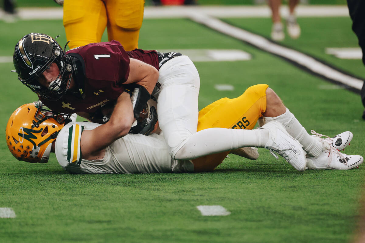 Faith Lutheran wide receiver Griffin Carry (1) holds onto the ball a he goes down during a clas ...