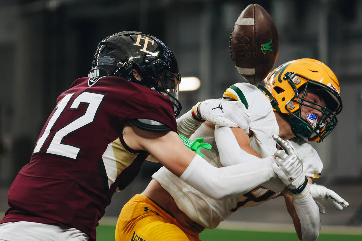 Faith Lutheran free safety Gavin Day (12) tackles a Bishop Manogue player in the end zone durin ...