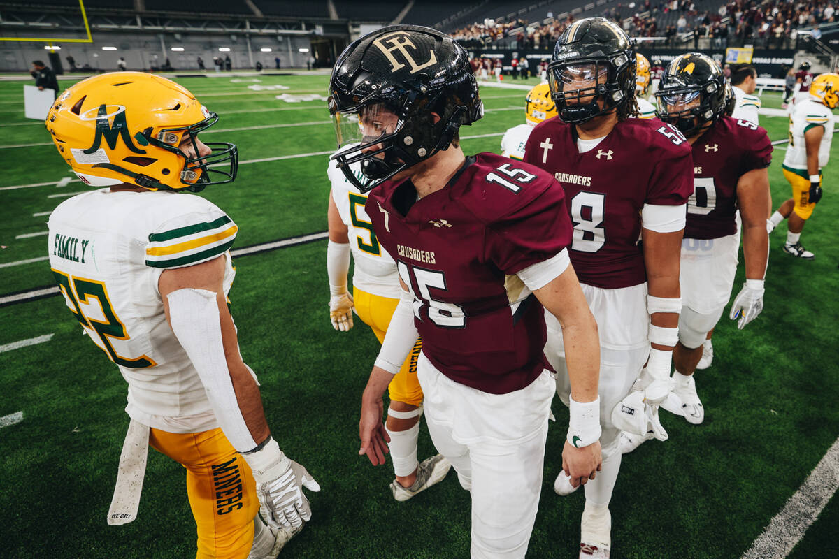 Bishop Manogue and Faith Lutheran players shake hands at the end of a class 5A Division II stat ...