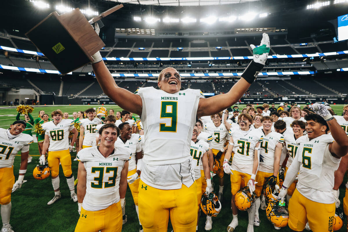 Bishop Manogue linebacker Marrio (cq) Williams Jr. (9) celebrates with a state championship tro ...