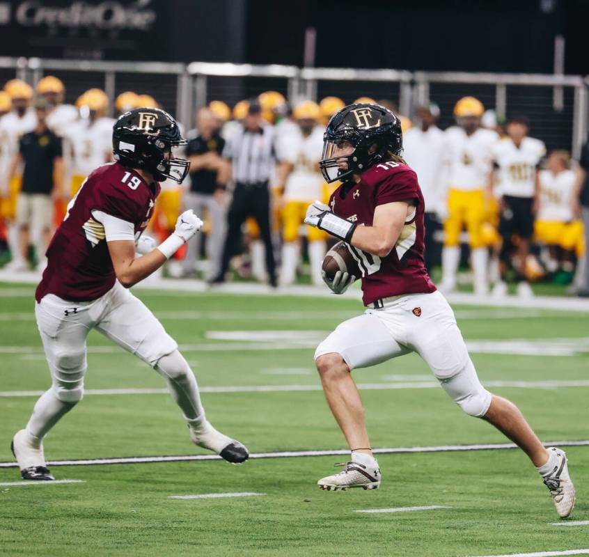 Faith lutheran quarterback Graham Radke (10) runs the ball to teammate and tight end Andrew O&# ...