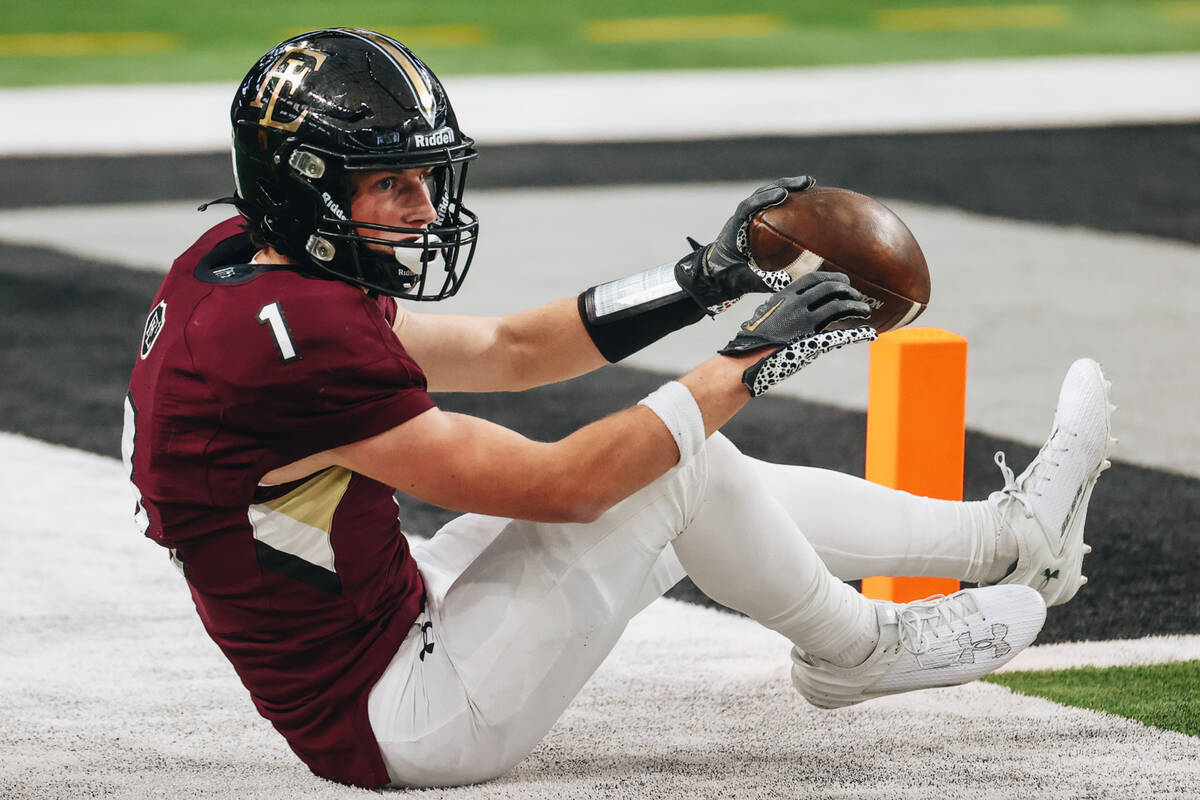 Faith lutheran wide receiver Griffin Carty falls after catching the ball right before the end z ...