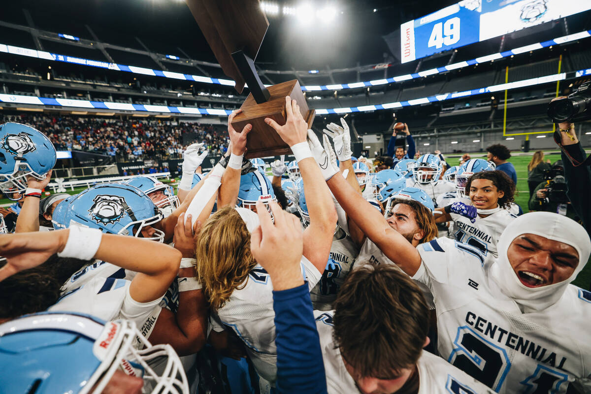 Centennial players celebrate a state championship win over Sunrise Mountain during a class 4A s ...