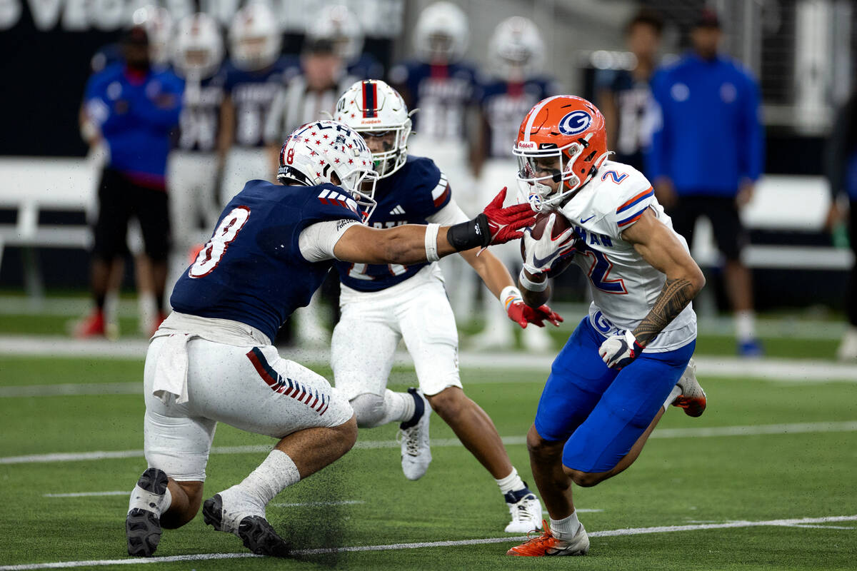 Bishop Gorman wide receiver Audric Harris (2) carries the ball while Liberty’s Louden Wi ...
