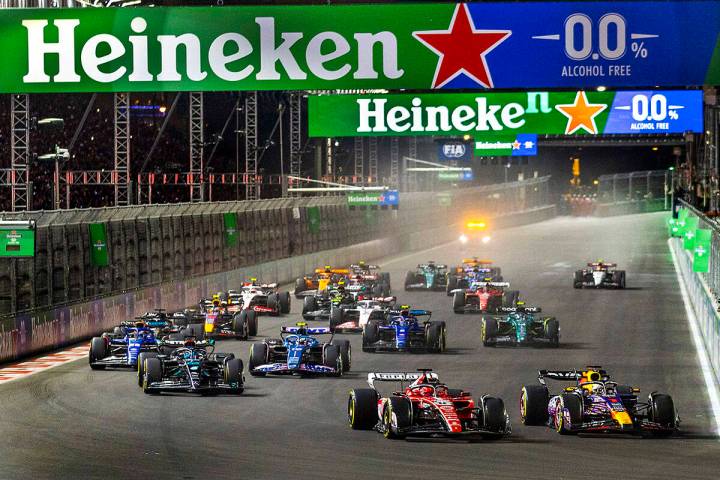 Red Bull Racing driver Max Verstappen leads Ferrari driver Charles Leclerc into turn one at the ...