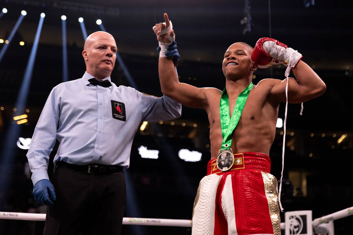 Curmel Moton, of Las Vegas, celebrates his knockout win over Ezequiel Flores in a super feather ...