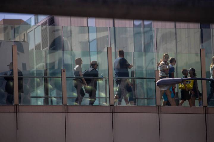 Pedestrians cross a bridge along the Las Vegas Strip on Wednesday, April 6, 2022, in Las Vegas. ...