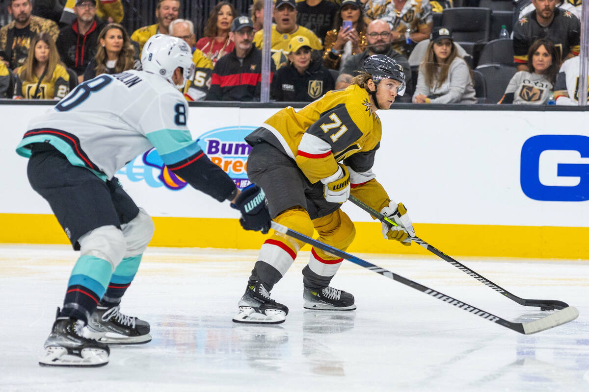 Golden Knights center William Karlsson (71) looks to pass ahead of Seattle Kraken defenseman Br ...