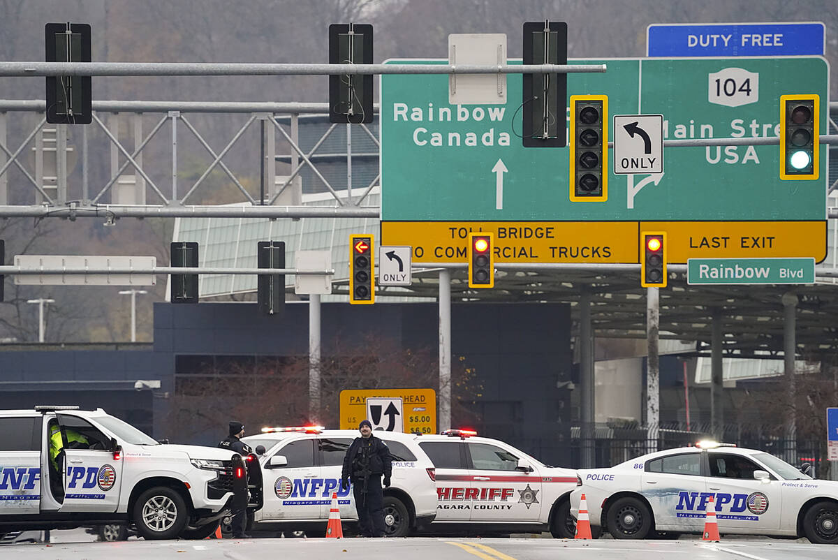 Law enforcement personnel block off the entrance to the Rainbow Bridge, Wednesday, Nov. 22, 202 ...