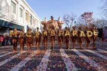 Parade performers lead the Tom Turkey float down Central Park West at the start of the Macy's T ...