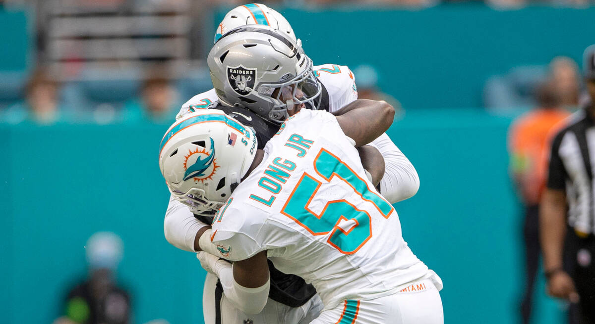 Raiders running back Josh Jacobs (8) is stopped by Miami Dolphins linebacker Bradley Chubb (2) ...