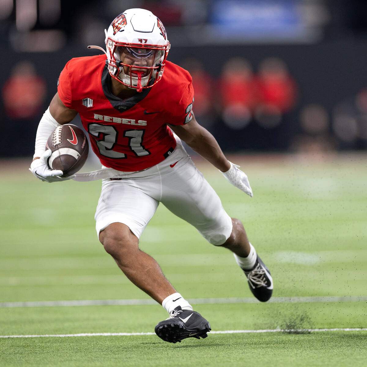UNLV wide receiver Jacob De Jesus (21) runs the ball during the first half of an NCAA college ...