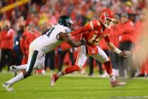 Kansas City Chiefs quarterback Patrick Mahomes (15) escapes the grip of Philadelphia Eagles def ...