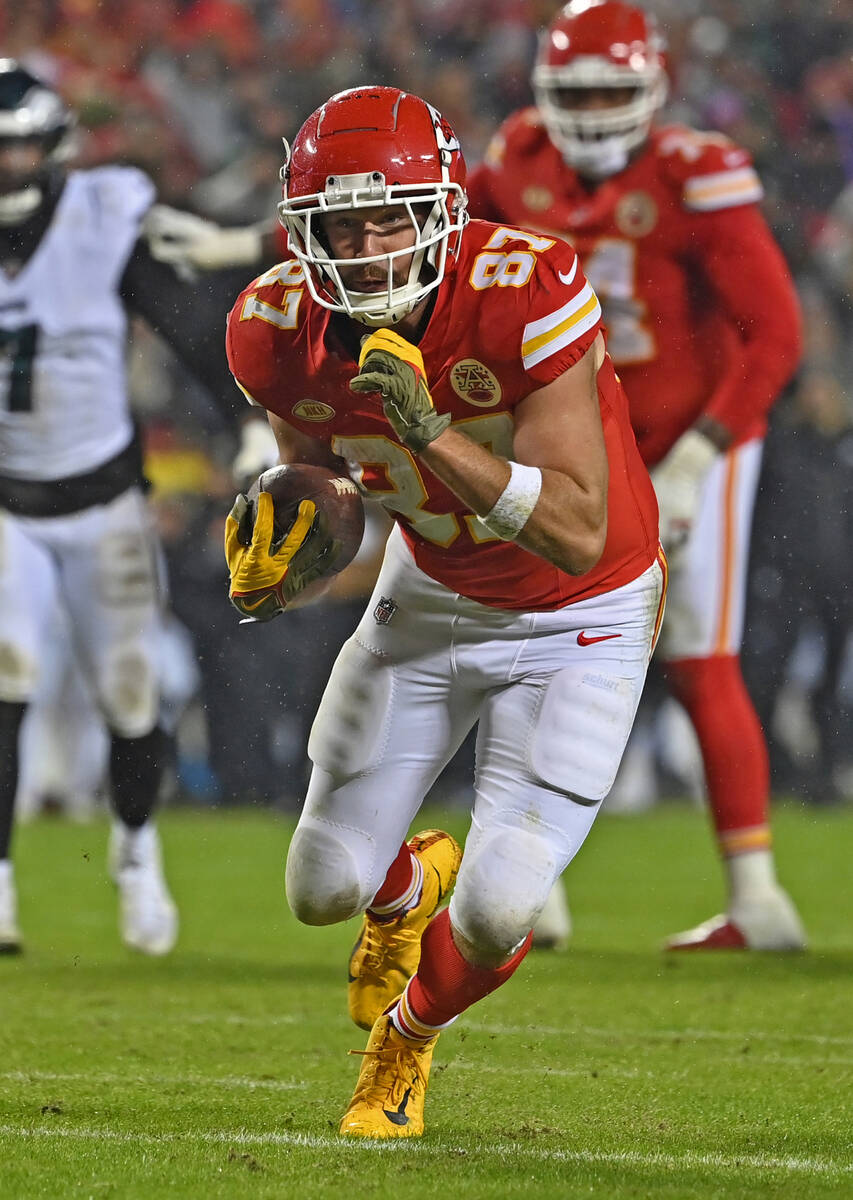 Kansas City Chiefs tight end Travis Kelce (87) runs down field with the ball after catching a p ...