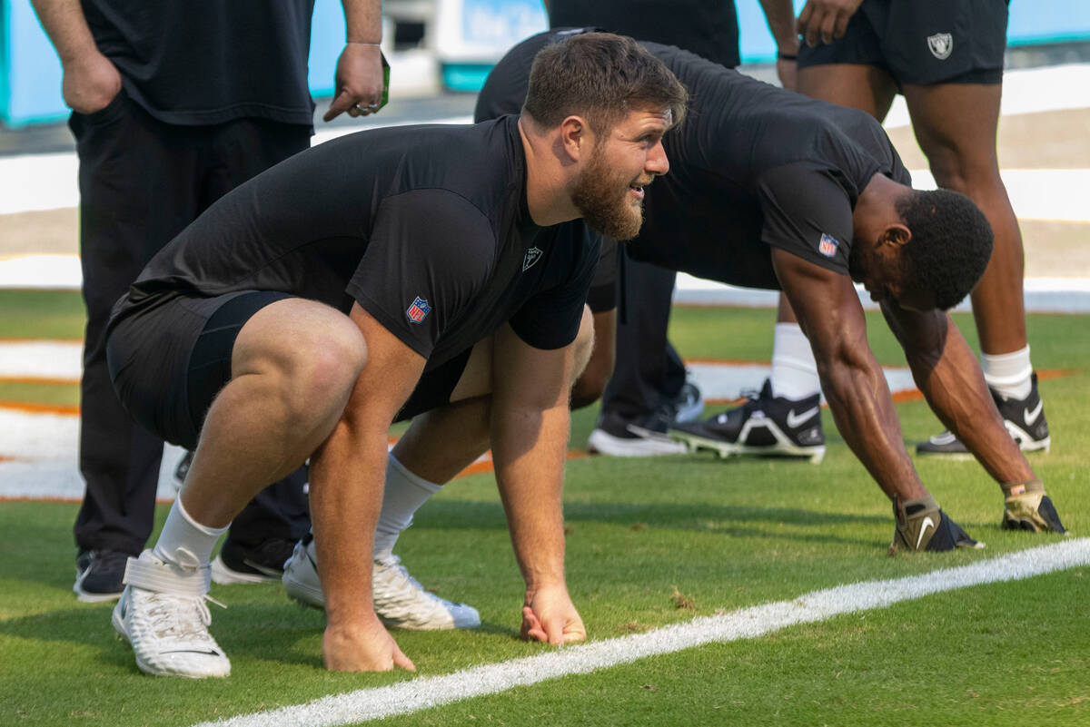 Raiders offensive tackle Kolton Miller stretches before an NFL game against the Miami Dolphins ...