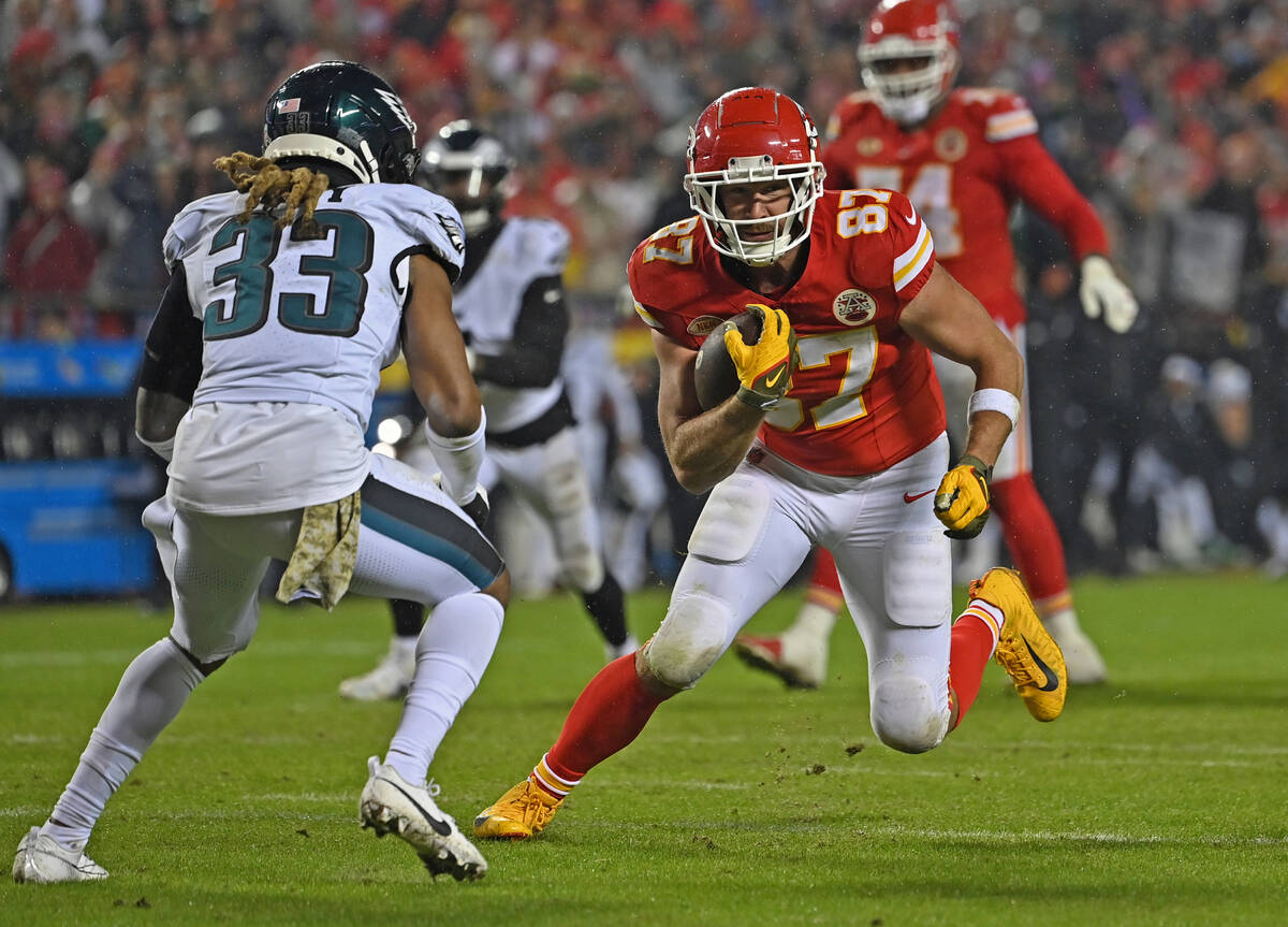 Kansas City Chiefs tight end Travis Kelce (87) runs down field with the ball after catching a p ...