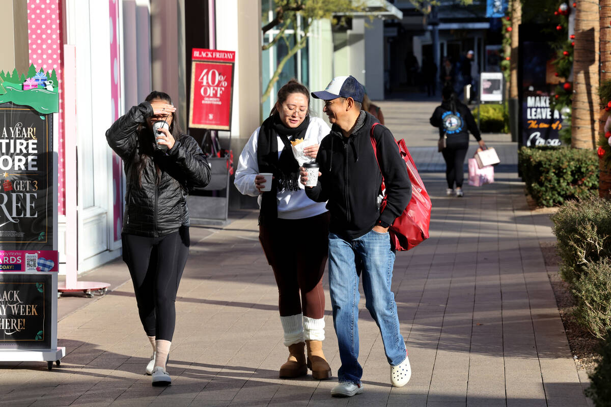 Shoppers walk through Downtown Summerlin in Las Vegas on Black Friday, Nov. 24, 2023. (K.M. Can ...