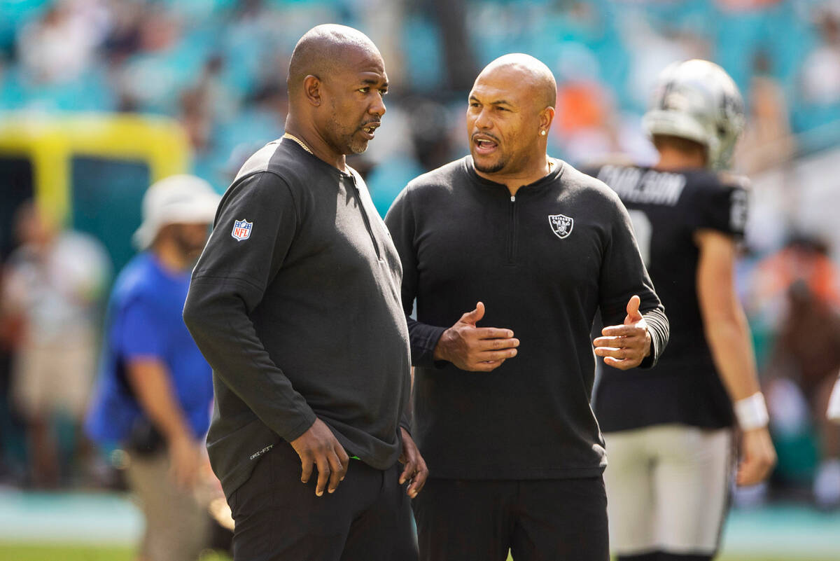 Raiders defensive coordinator Patrick Graham, left, and interim head coach Antonio Pierce inte ...