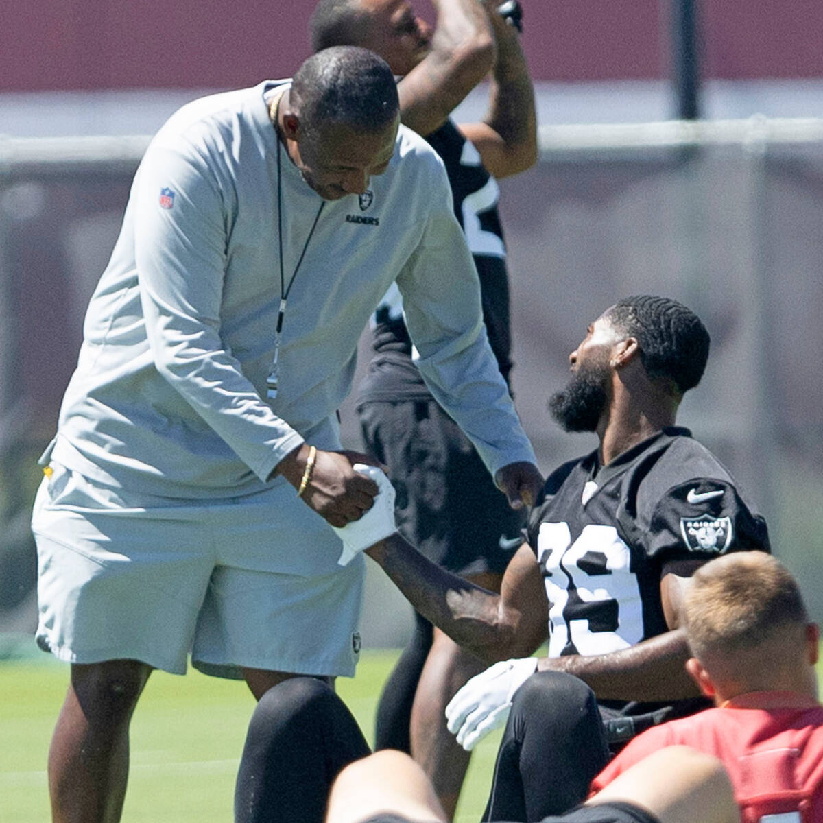 Raiders defensive coordinator Patrick Graham greets cornerback Nate Hobbs (39) with a handshake ...