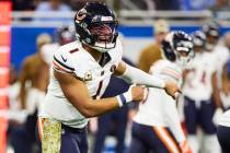 Chicago Bears quarterback Justin Fields (1) gets set to run a play against the Detroit Lions du ...