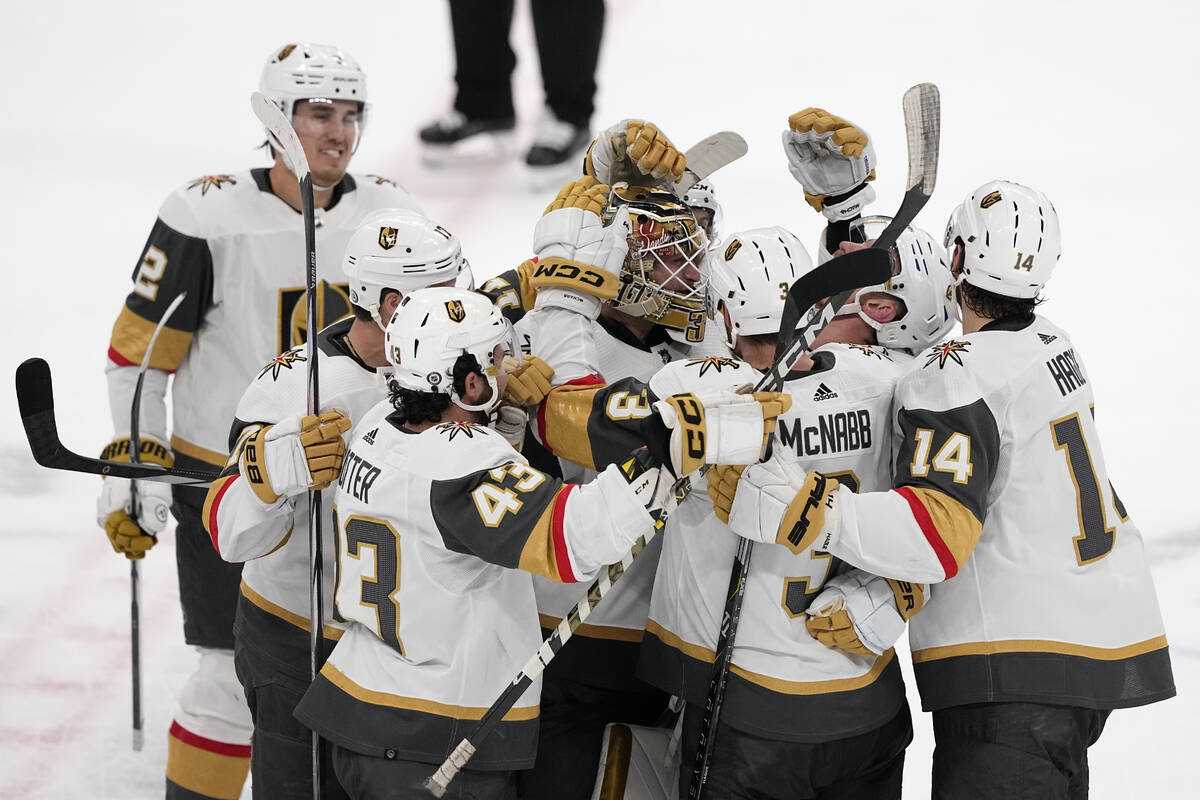 Vegas Golden Knights center Jack Eichel, second from right, celebrates with teammates his game- ...