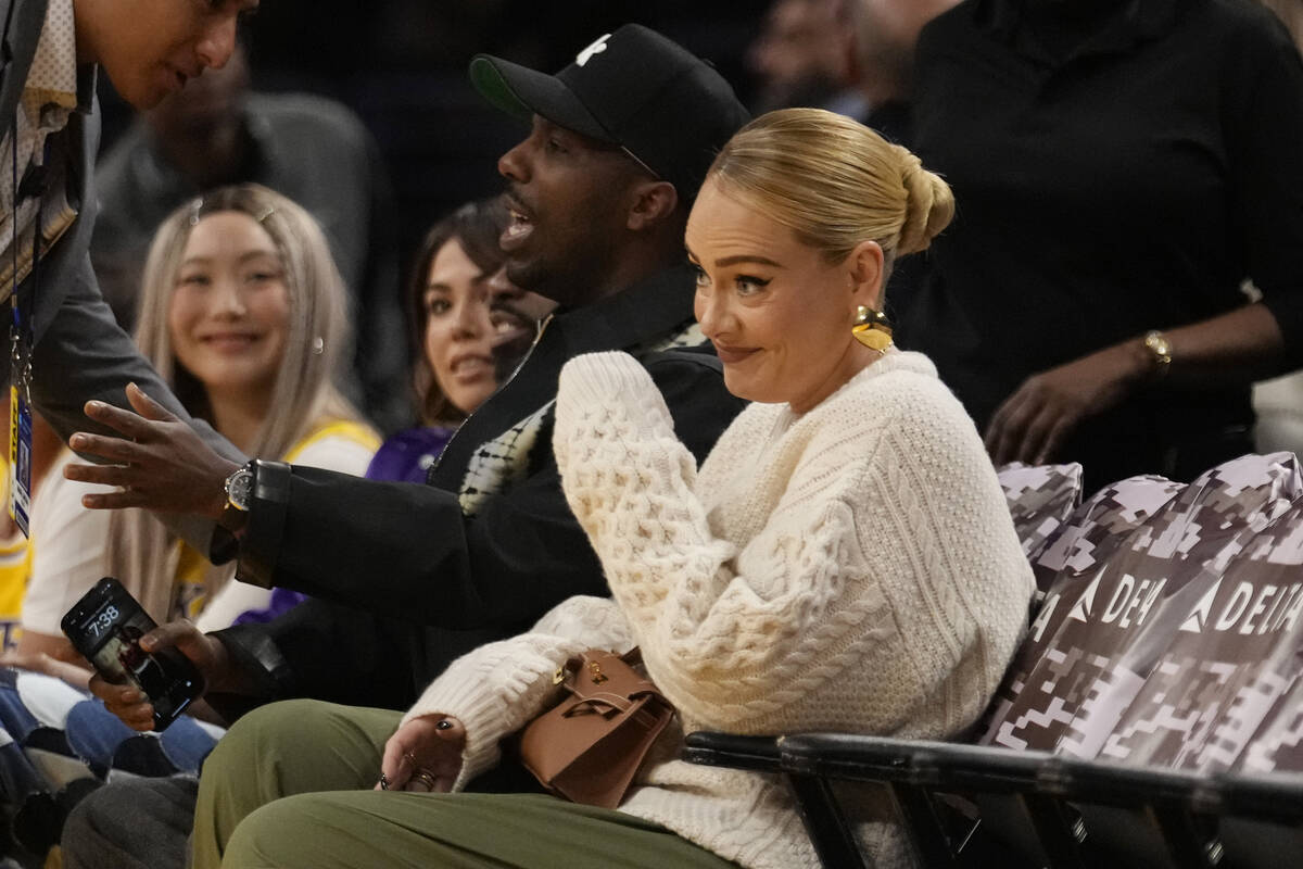 Singer Adele sits with Rich Paul during an NBA basketball game between the Los Angeles Lakers a ...