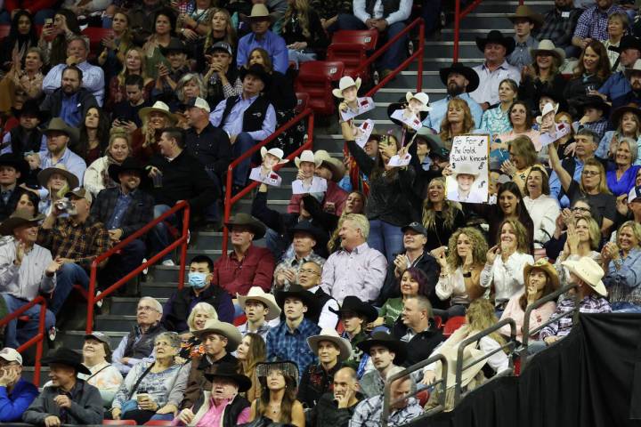 Fans cheer for Kincade Henry after his run in the tie-down roping event during the 64th Wrangle ...