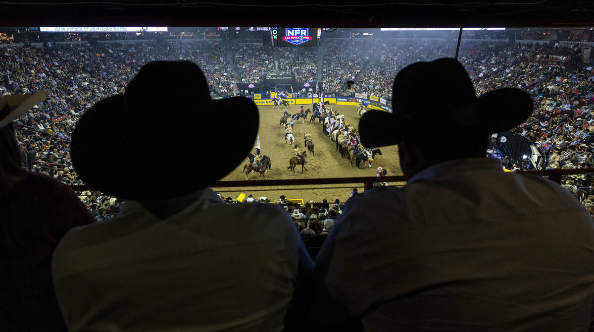 Rodeo fans look on as the competitors enter the ring during the National Finals Rodeo Day 4 at ...