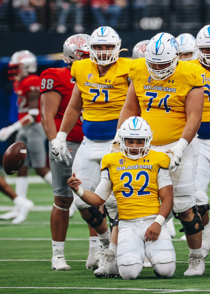 San Jose State running back Kairee Robinson (32) collects himself after getting tackled while r ...