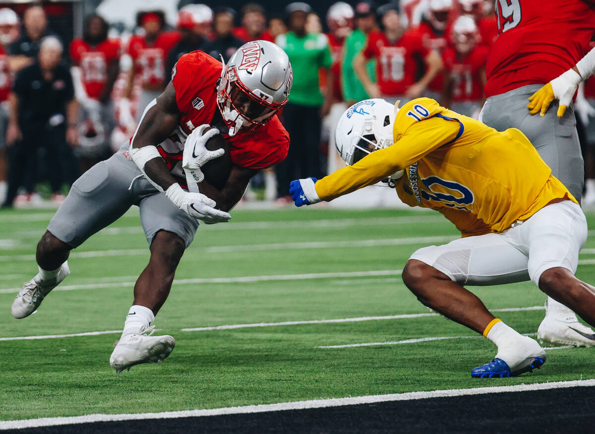 UNLV running back Jai'Den Thomas (22) makes it into the end zone for a touchdown during a footb ...