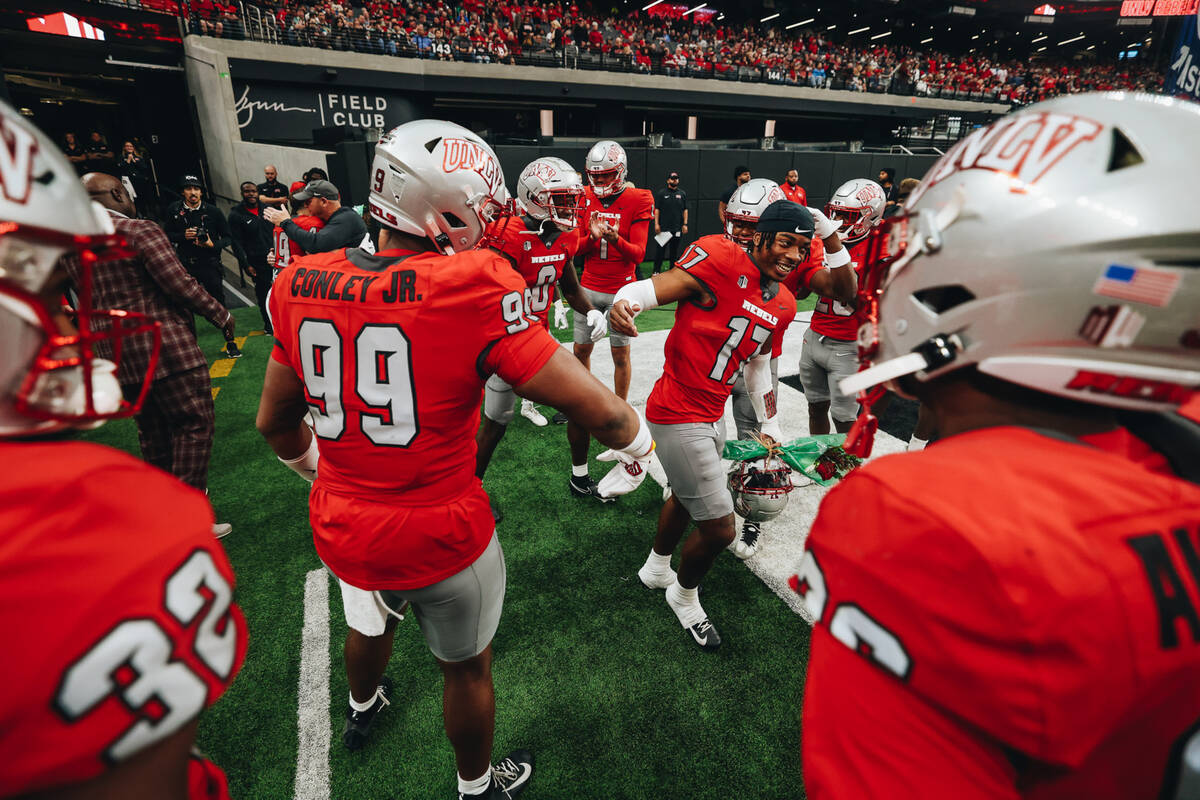 UNLV defensive back Kris Williams (17) is honored by his. Teammates before participating in a S ...