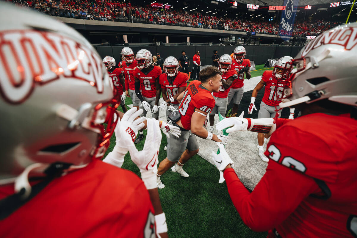 UNLV running back Andrew Wimmer (49) is honored during a Senior Day ceremony before a football ...