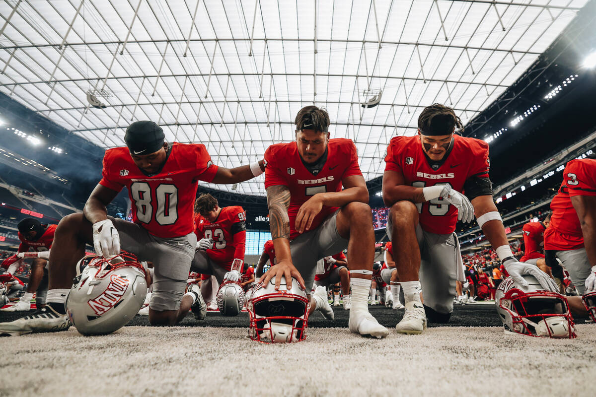 UNLV players pray in the end zone before a football game against San Jose State at Allegiant St ...