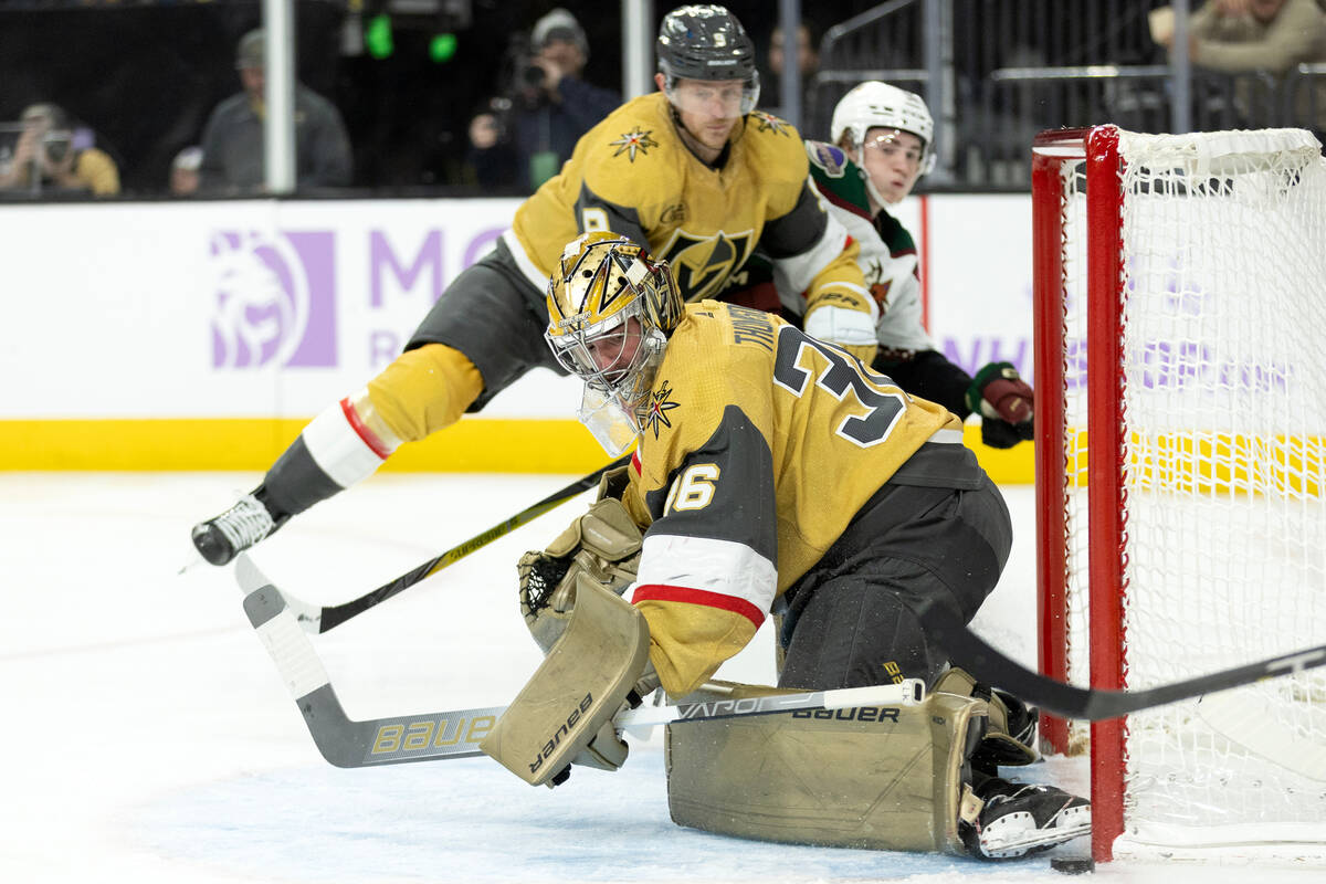 Golden Knights goaltender Logan Thompson (36) saves the puck against the Coyotes during the thi ...