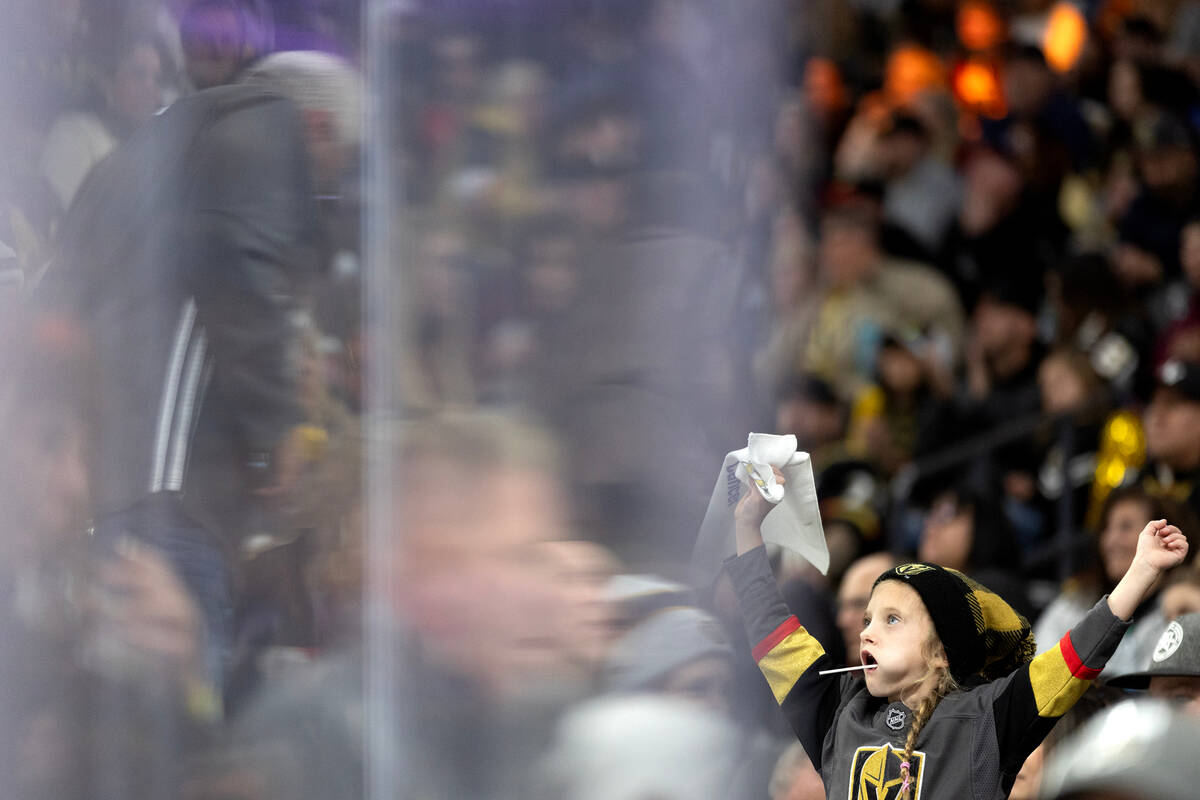 A young fan cheers for the Golden Knights during the second period of an NHL hockey game agains ...