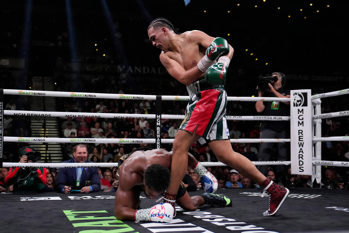 David Benavidez knocks down Demetrius Andrade in a super middleweight title boxing match, Satur ...
