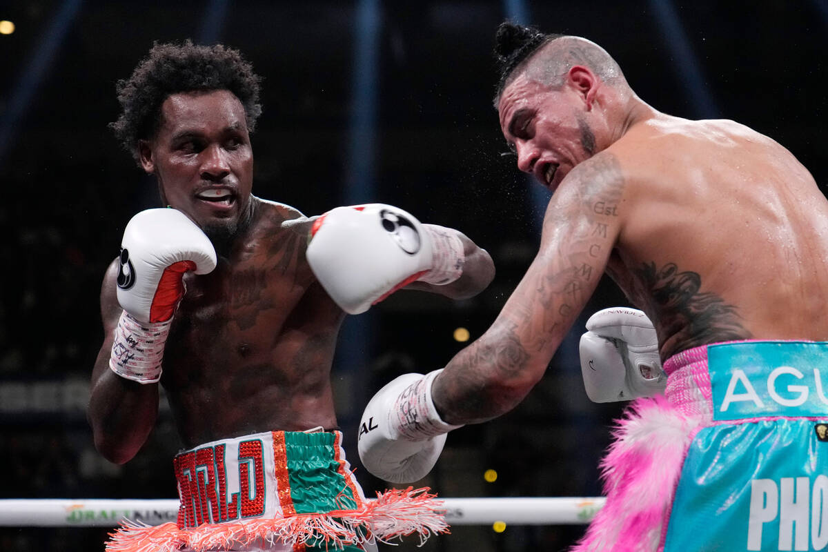 Jermall Charlo, left, hits Jose Benavidez Jr., right, during a middleweight boxing match Saturd ...