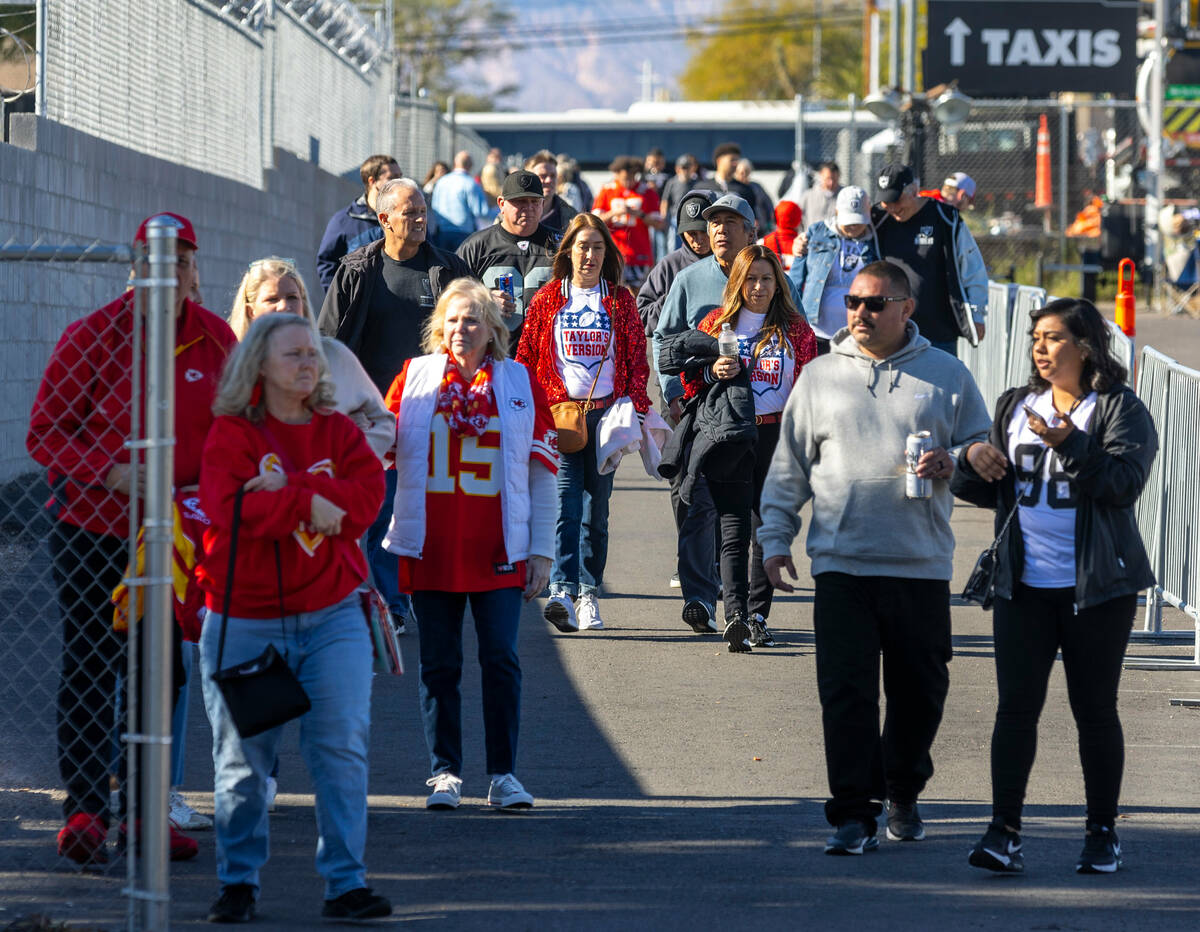 A few Kansas City Chiefs fans arrive wearing Taylor Swift shirts before facing the Raiders outs ...