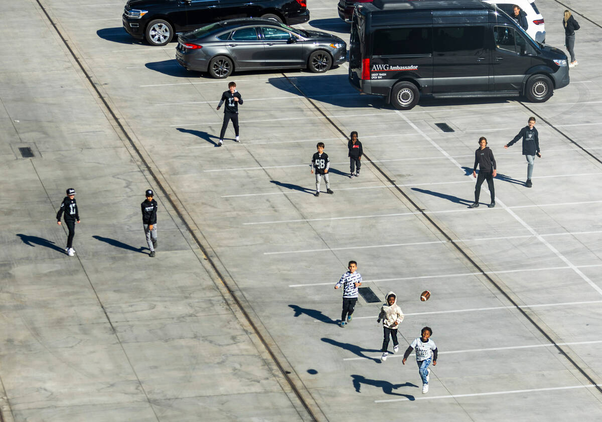 Fans plays parking lot football outside before the first half of the Raiders versus the Kansas ...