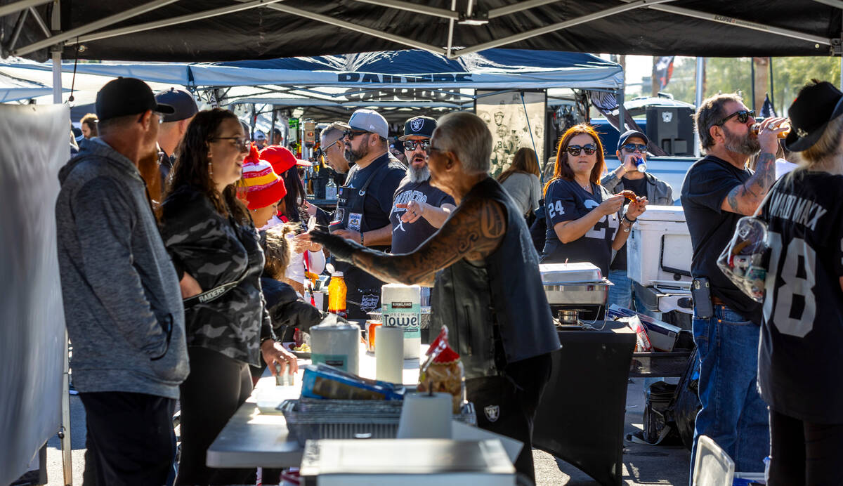 Fans enjoy food and conversation in tailgating before the first half of the Raiders versus the ...