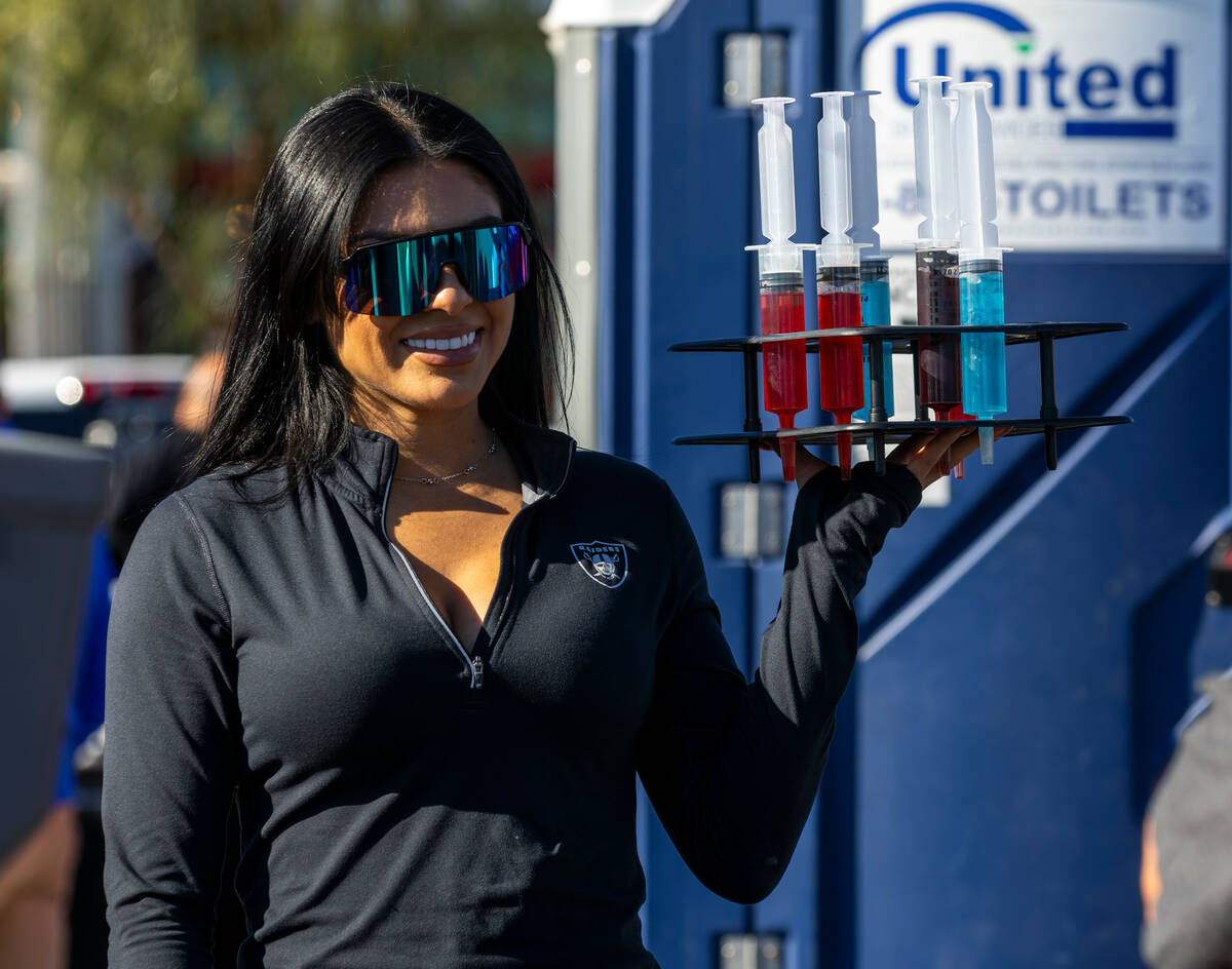 Fans can purchase giant shot alcohol in tailgating before the first half of the Raiders versus ...