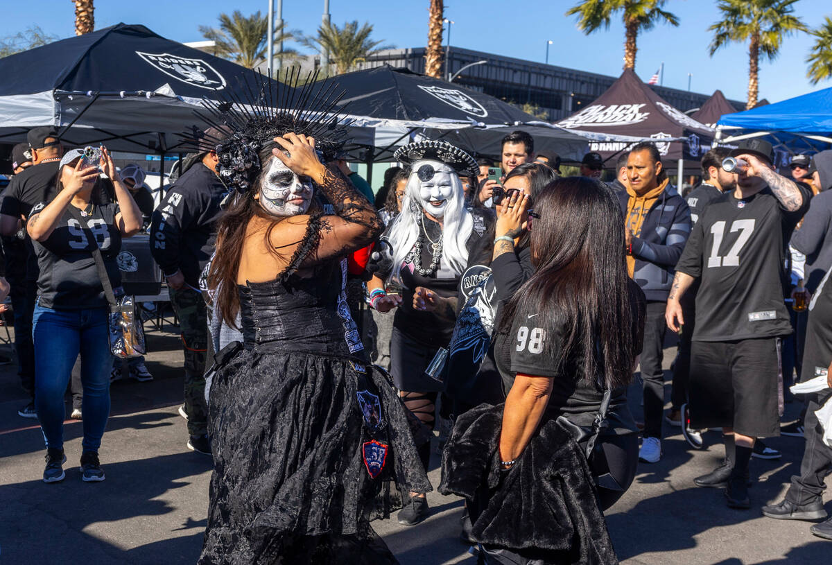 Fans dance in tailgating before the first half of the Raiders versus the Kansas City Chiefs NFL ...