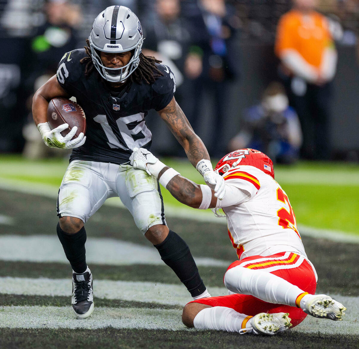 Raiders wide receiver Jakobi Meyers (16) scores as Kansas City Chiefs safety Mike Edwards (21) ...